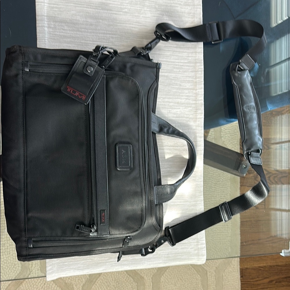 Tumi Black Briefcase with Durable Design and Multiple Compartments